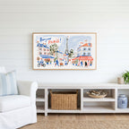 Bonjour Paris Frame TV art above a white console with a rattan basket in a coastal living room
