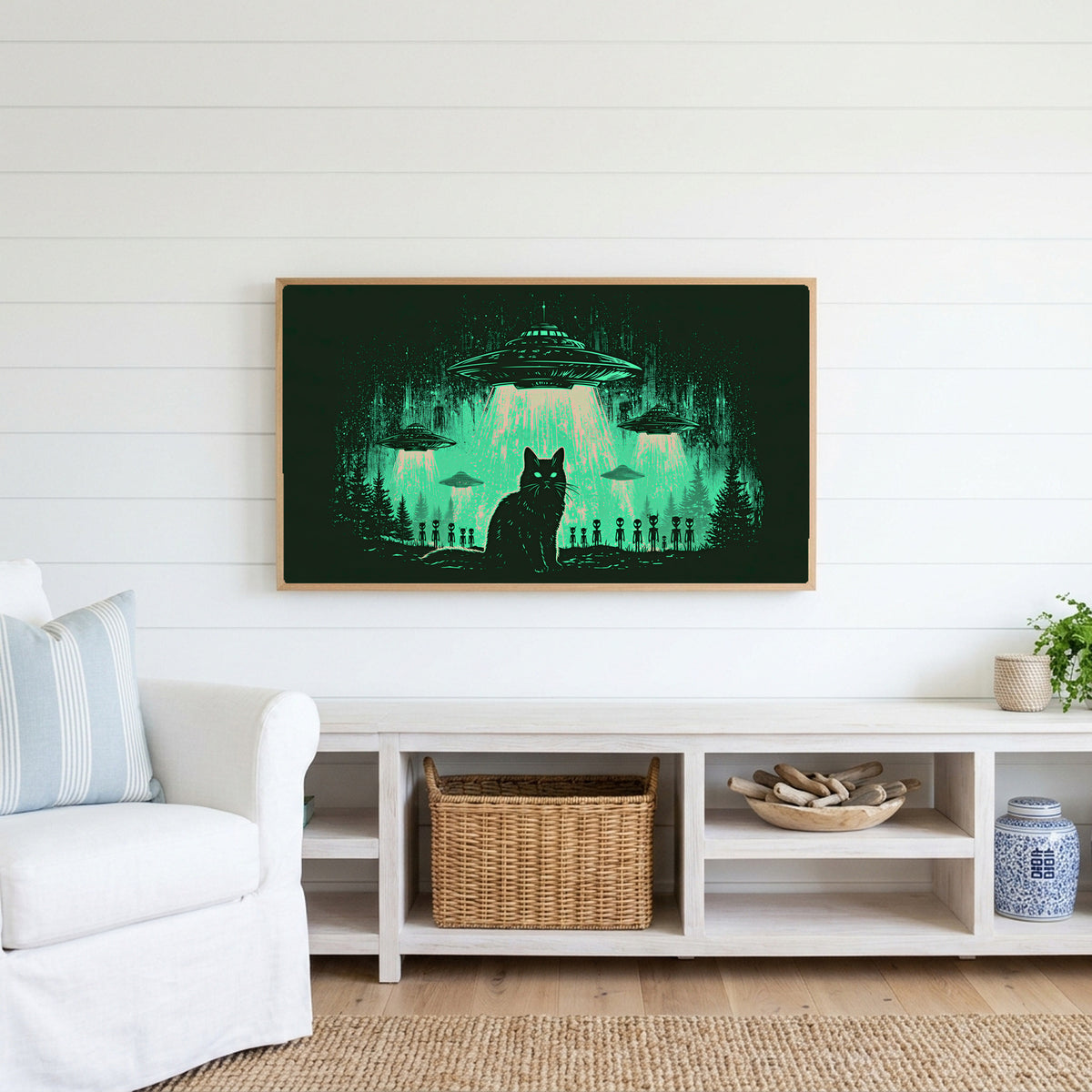 Black cat UFO Frame TV art above a white console with a rattan basket in a coastal living room