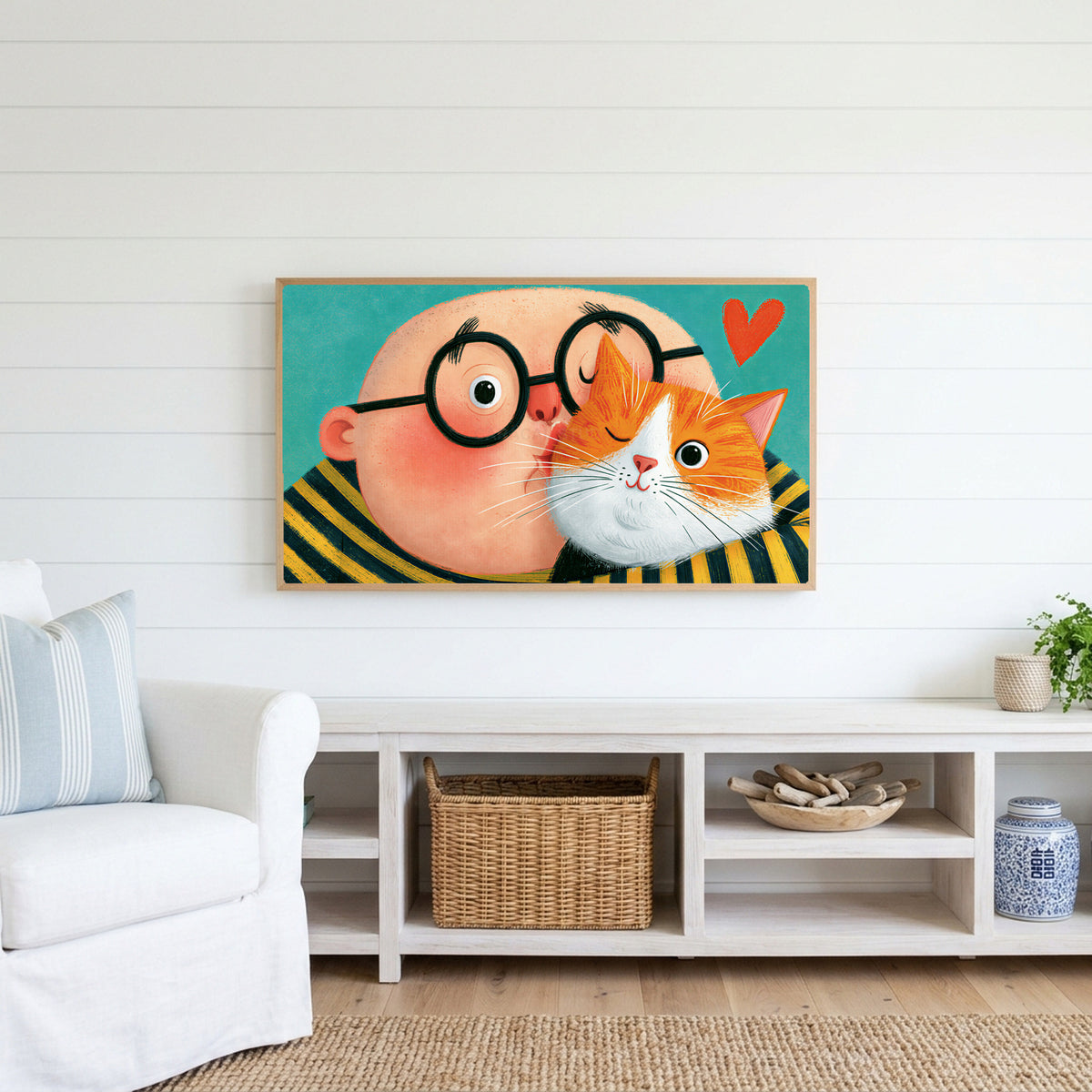 Man with his ginger cat Frame TV art above a white console with a rattan basket in a coastal living room