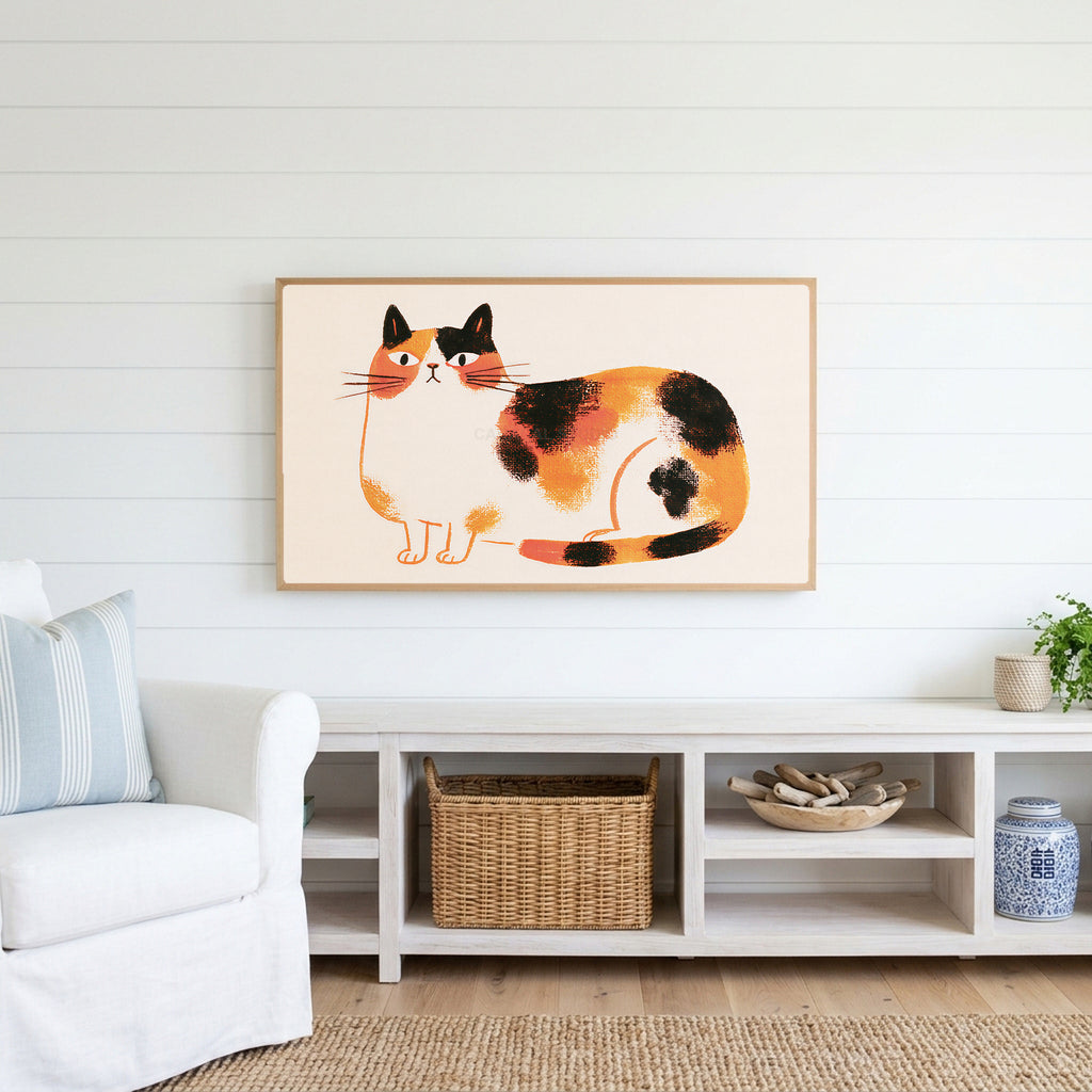 Calico cat Frame TV art above a white console with a rattan basket in a coastal living room