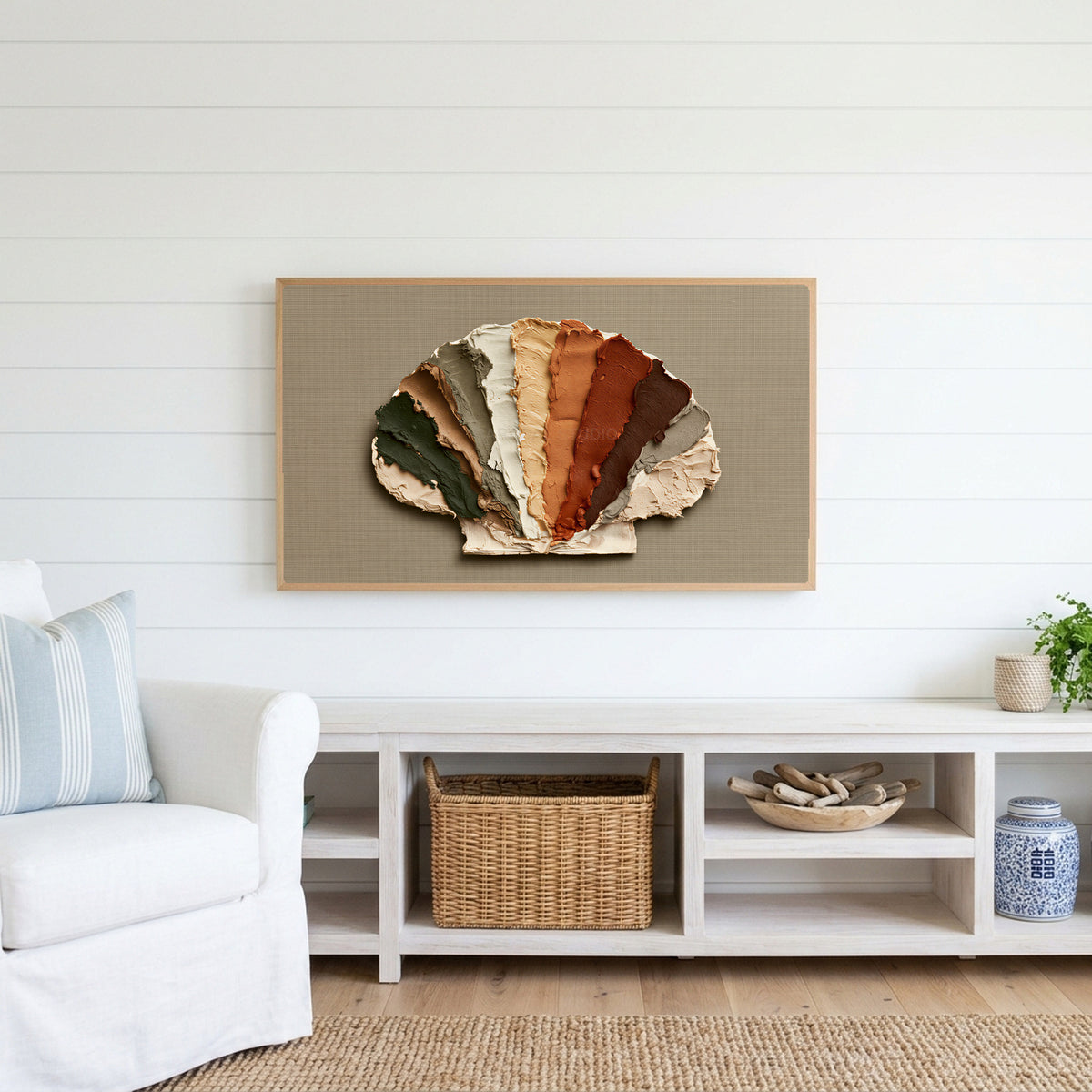 Earthy impasto seashell Frame TV art above a white console with a rattan basket in a coastal living room