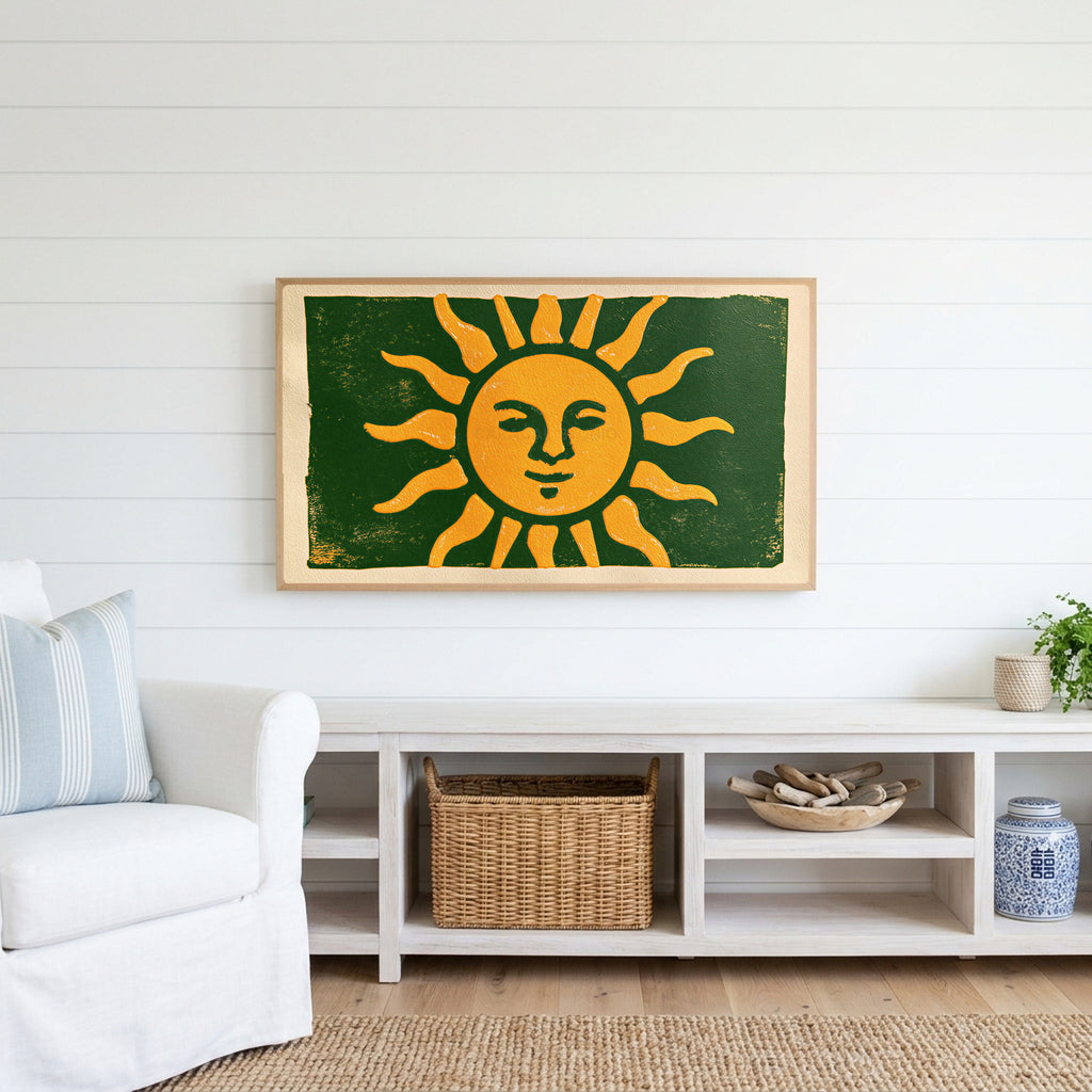 Woodblock sun Frame TV art above a white console with a rattan basket in a coastal living room