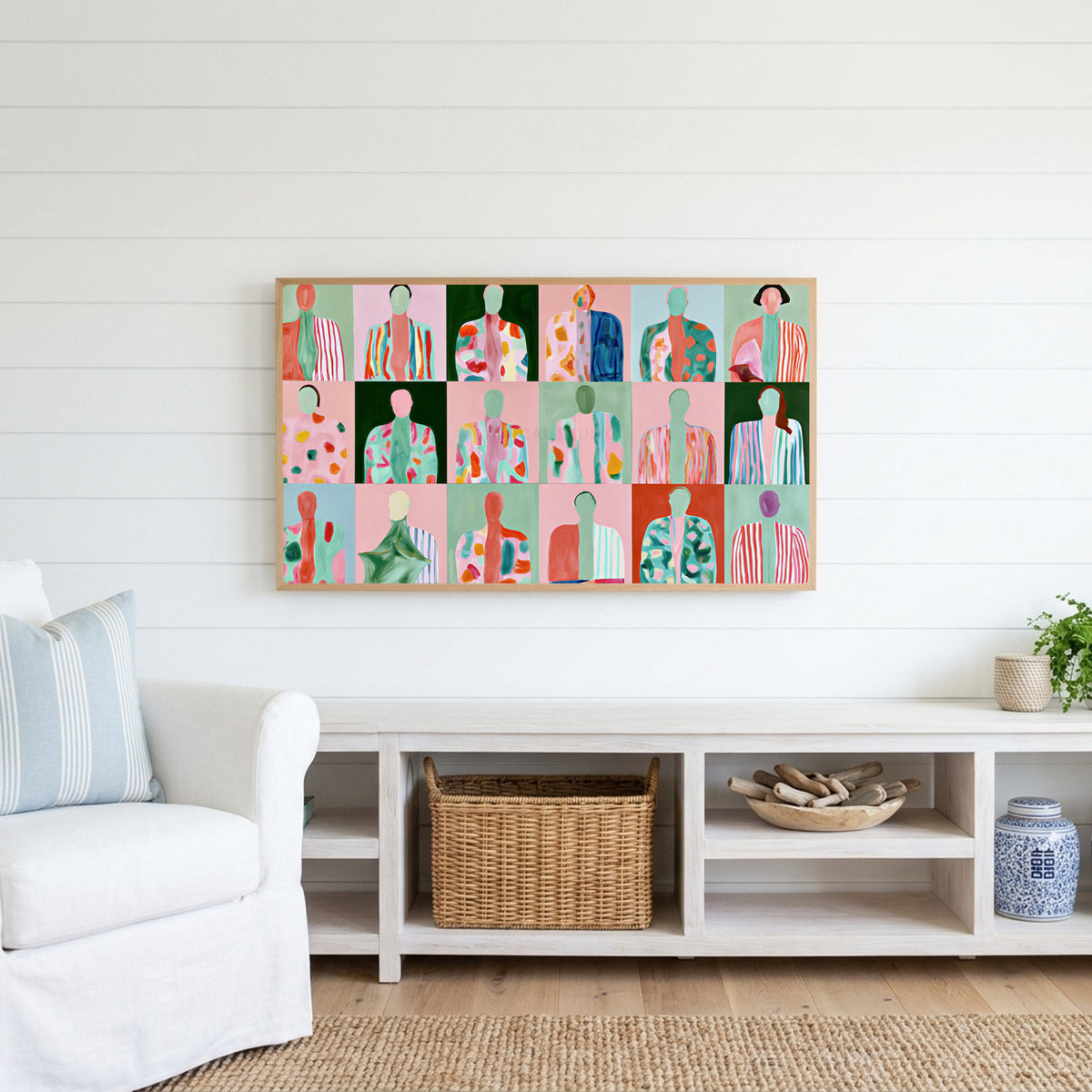Faceless portraits Frame TV art above a white console with a rattan basket in a coastal living room