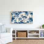Blue botanical Frame TV art above a white console with a rattan basket in a coastal living room