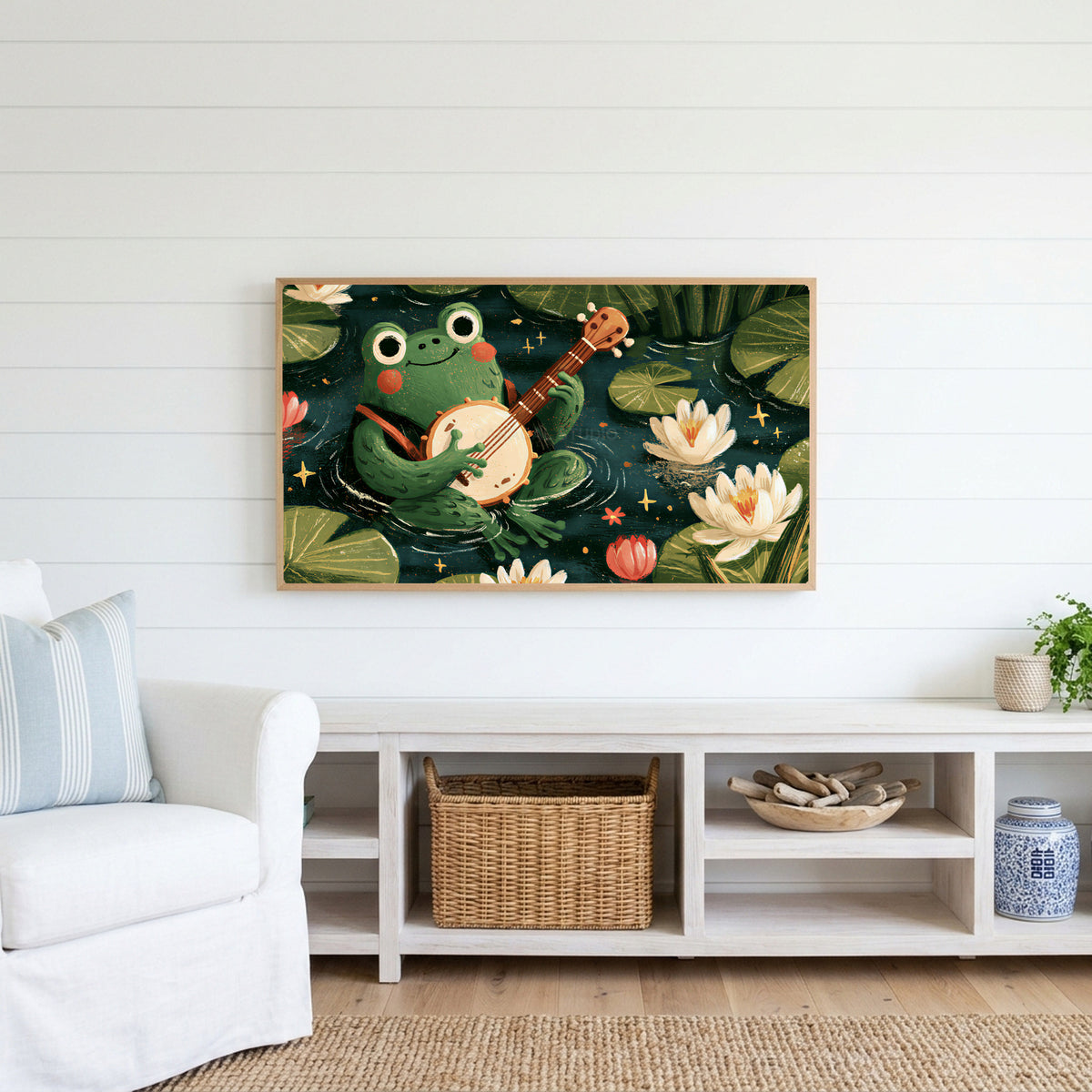 Frog playing a banjo Frame TV art above a white console with a rattan basket in a coastal living room