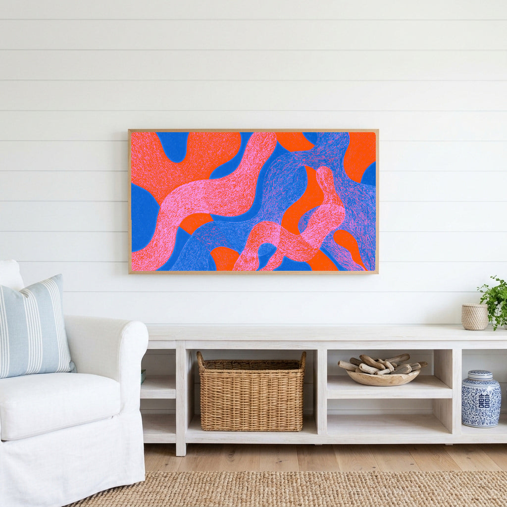 Wavy abstract shapes Frame TV art above a white console with a rattan basket in a coastal living room