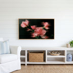 Ribbed glass flowers Frame TV art above a white console with a rattan basket in a coastal living room
