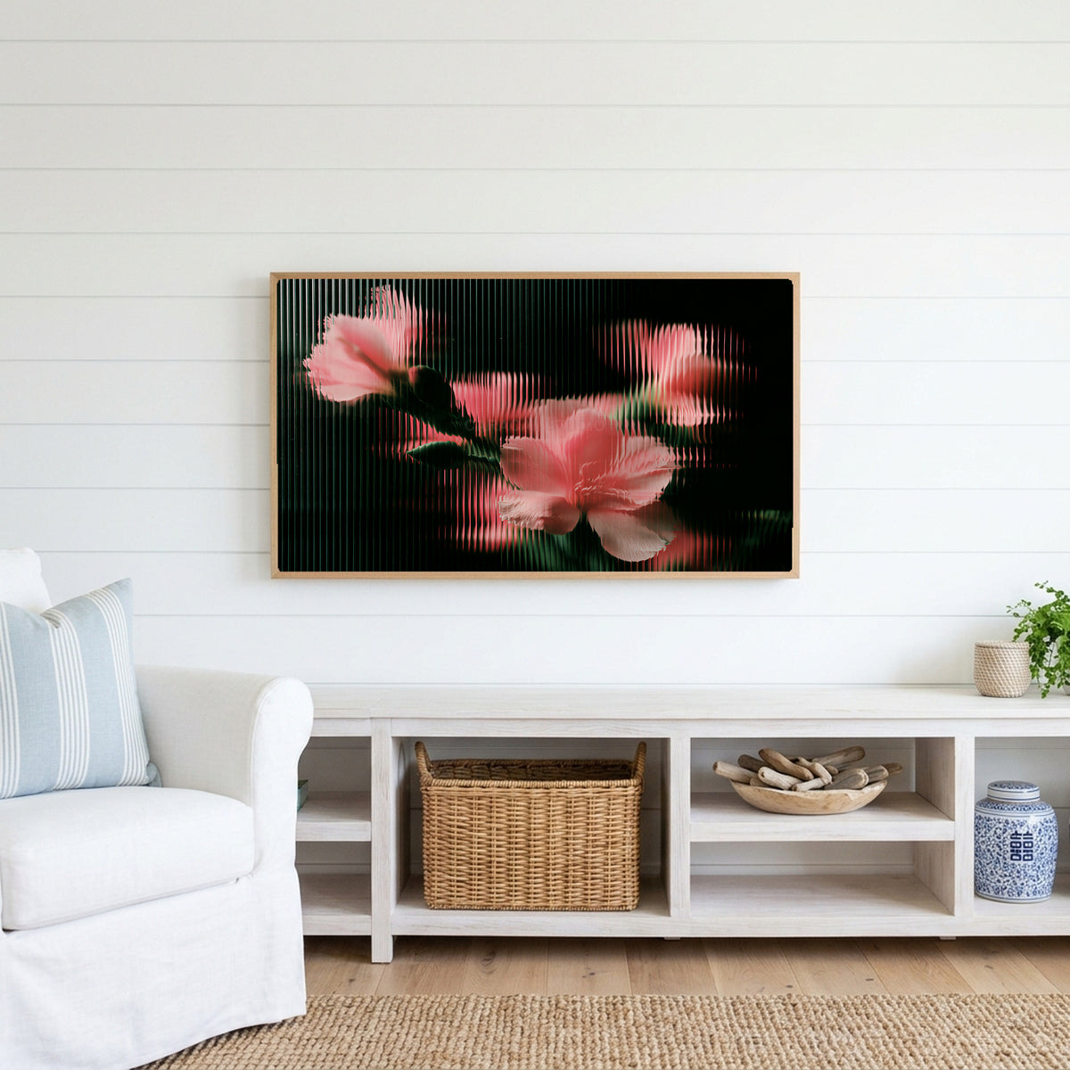 Ribbed glass flowers Frame TV art above a white console with a rattan basket in a coastal living room