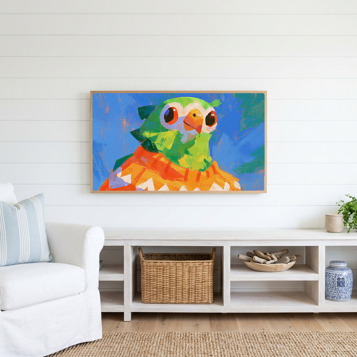 Parrot in a sweater Frame TV art above a white console with a rattan basket in a coastal living room