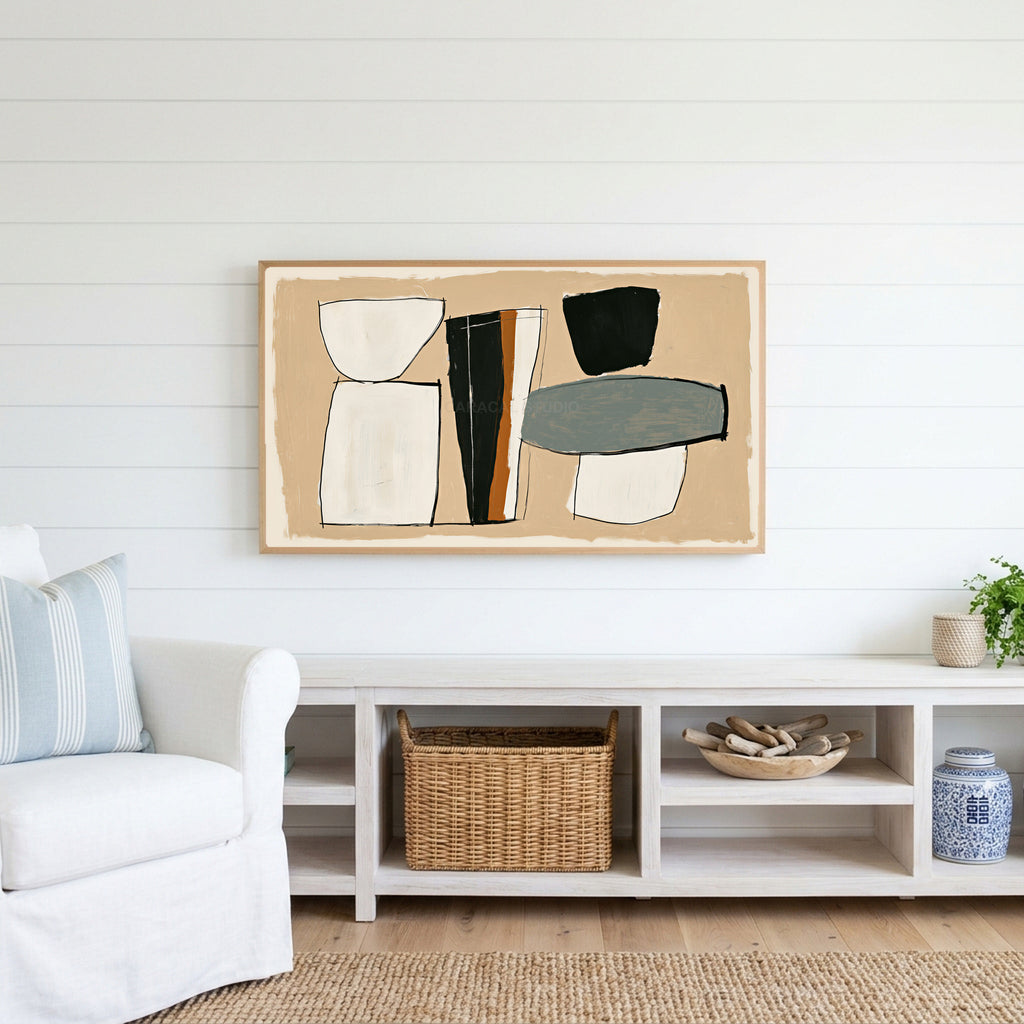 Mid century abstract shapes Frame TV art above a white console with a rattan basket in a coastal living room