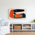 Abstract organic shapes Frame TV art above a white console with a rattan basket in a coastal living room