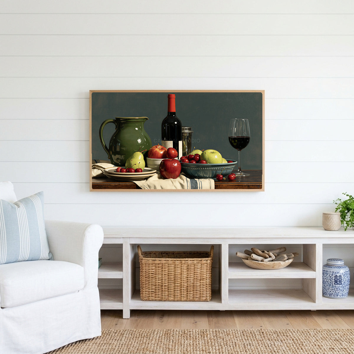 Wine and fruit still life Frame TV art above a white console with a rattan basket in a coastal living room