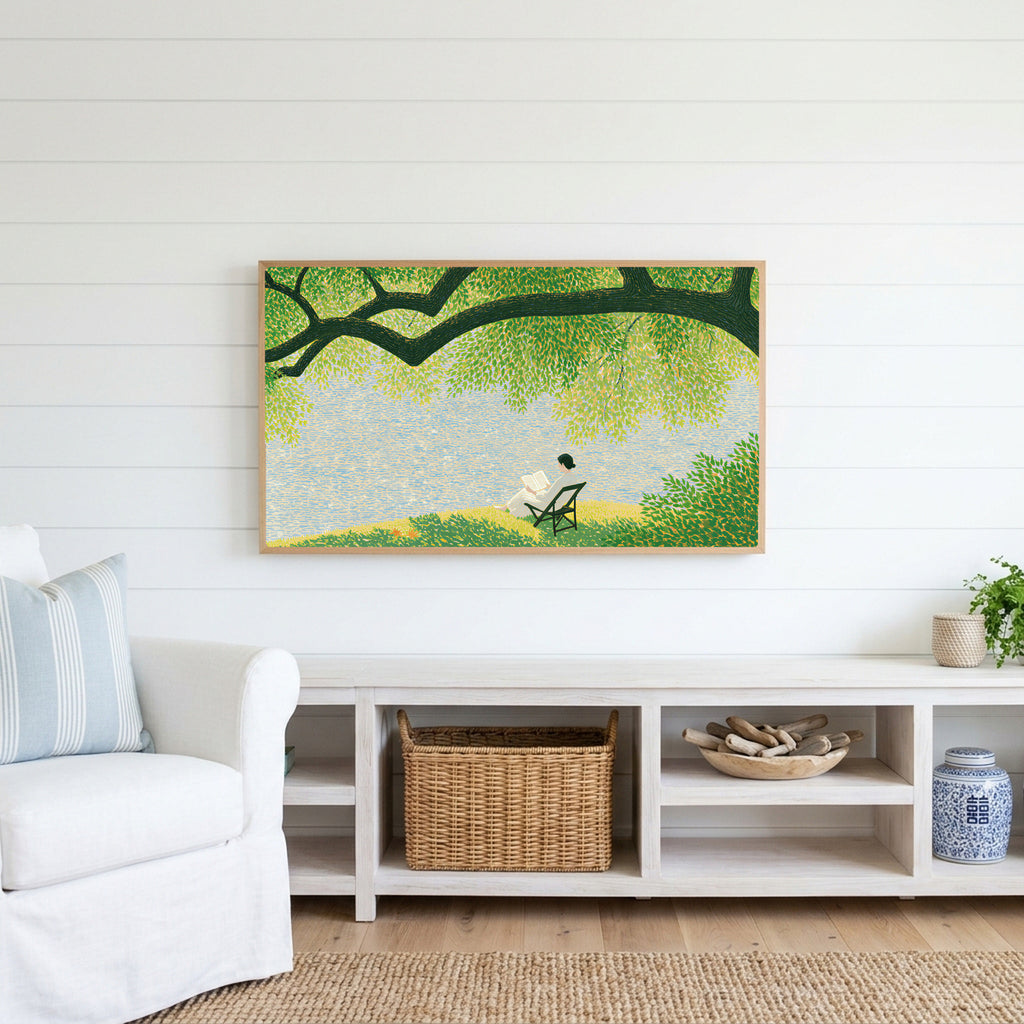 Lake and tree landscape Frame TV art above a white console with a rattan basket in a coastal living room