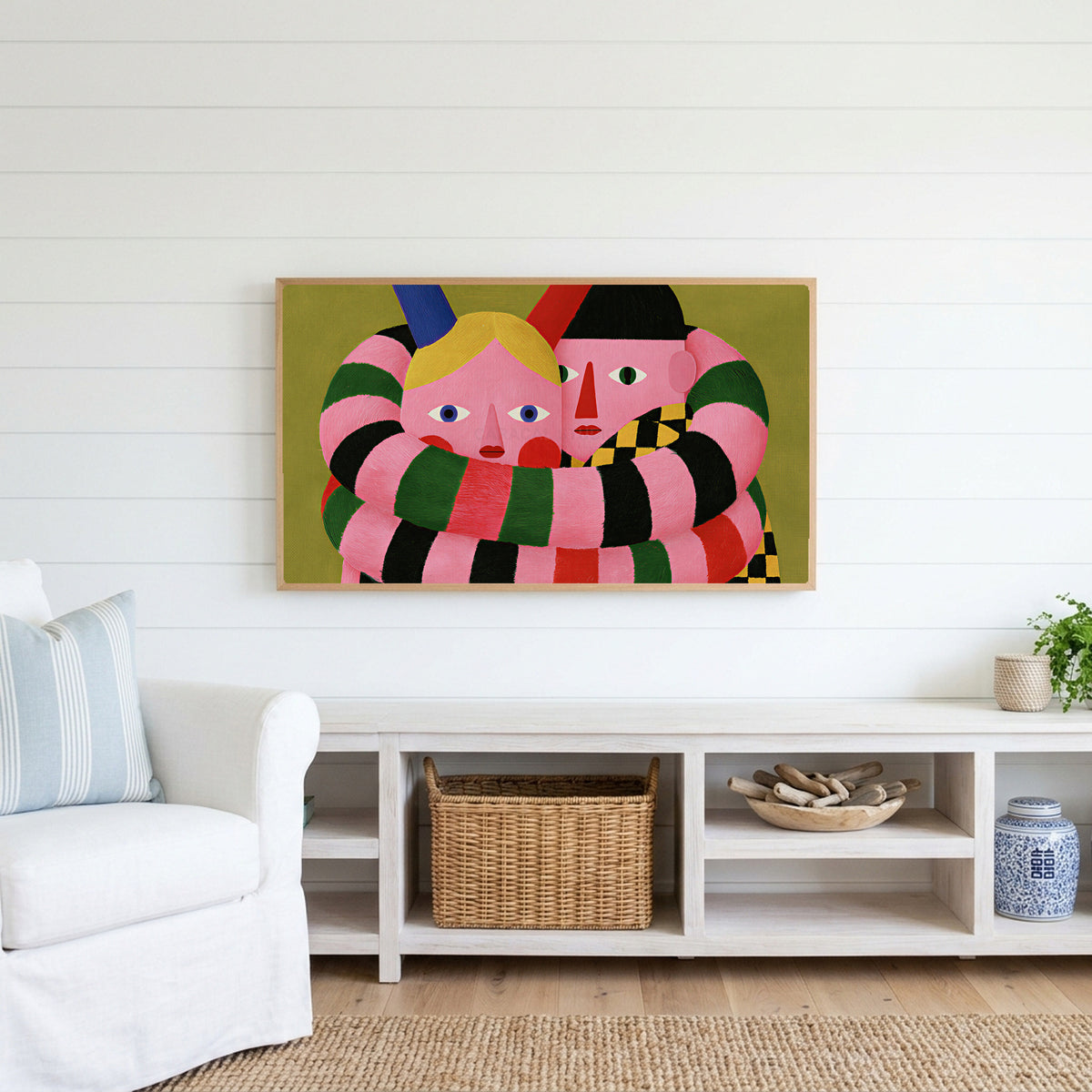 Long striped arms portrait Frame TV art above a white console with a rattan basket in a coastal living room