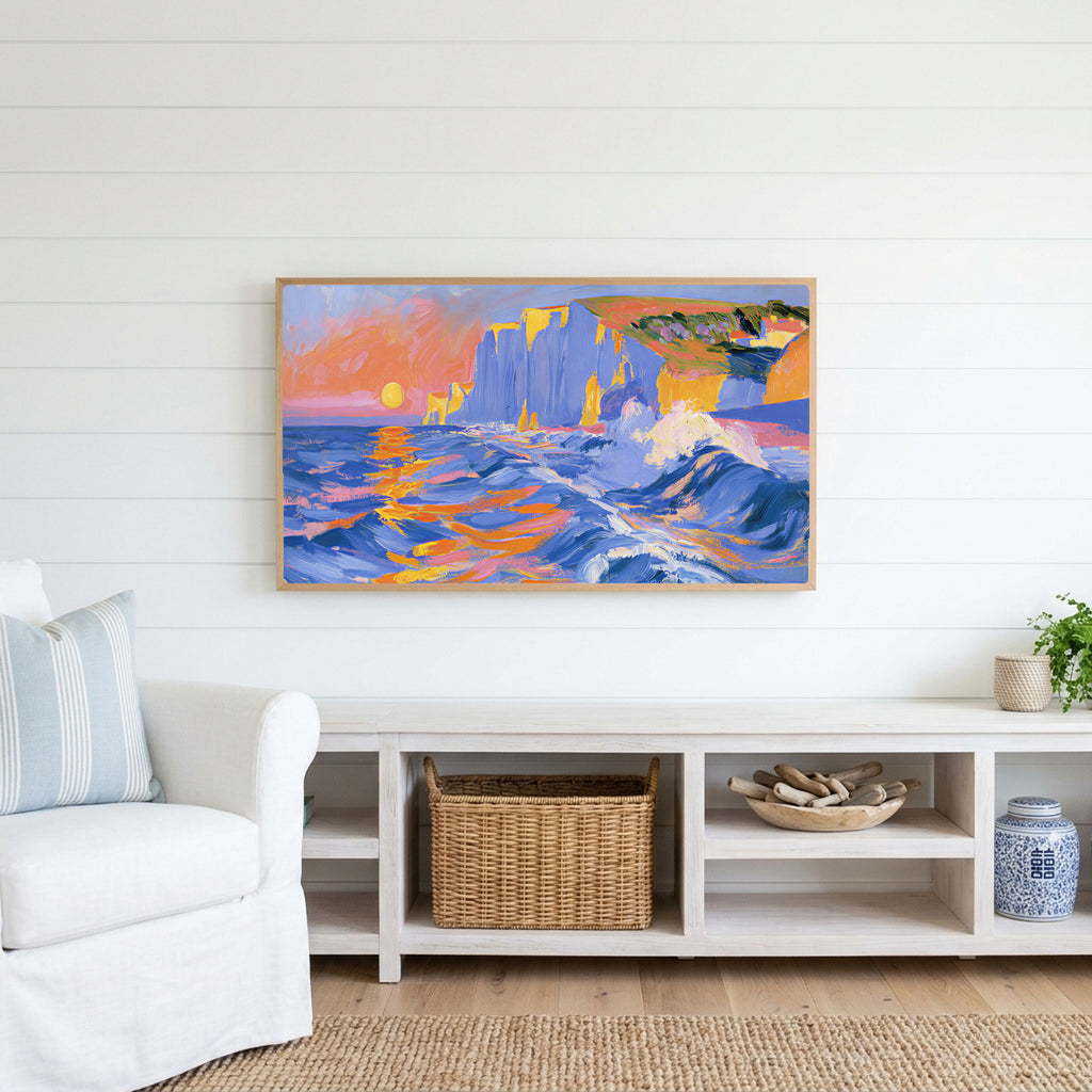 Sunset sea cliffs Frame TV art above a white console with a rattan basket in a coastal living room