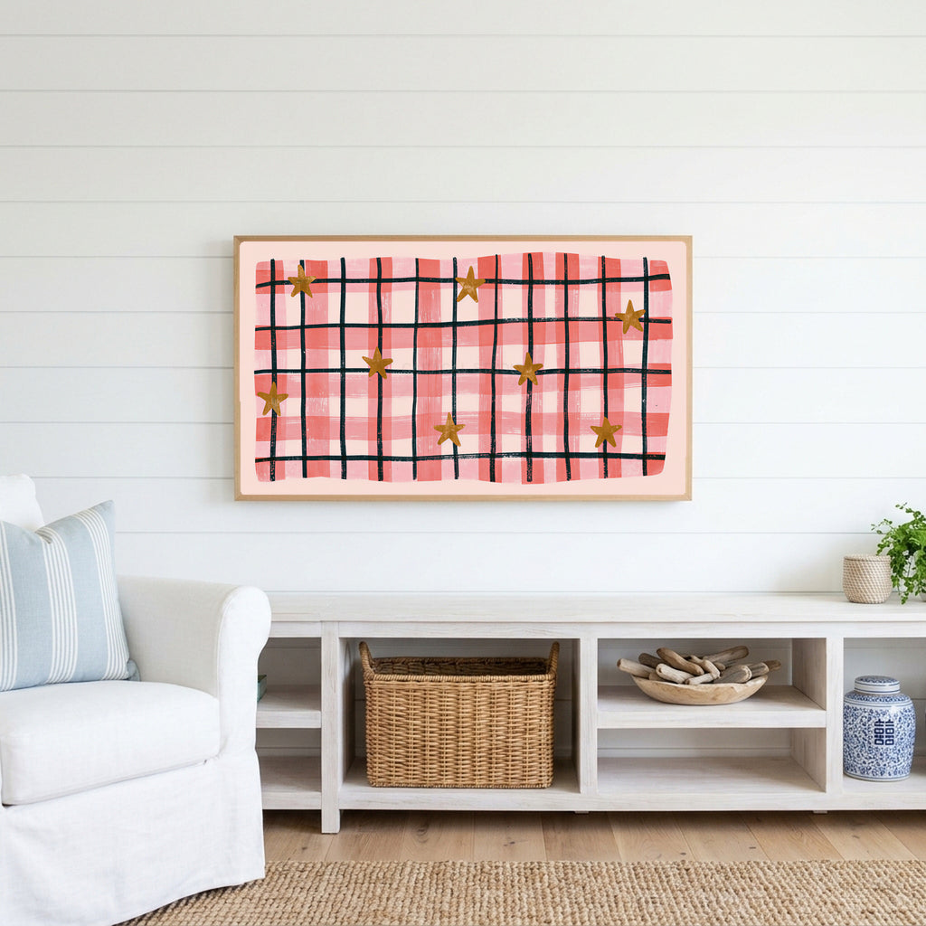 Gingham plaid with stars Frame TV art above a white console with a rattan basket in a coastal living room