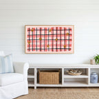 Gingham plaid with stars Frame TV art above a white console with a rattan basket in a coastal living room