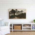Misty pine forest path Frame TV art above a white console with a rattan basket in a coastal living room