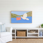 Dove with a letter Frame TV art above a white console with a rattan basket in a coastal living room