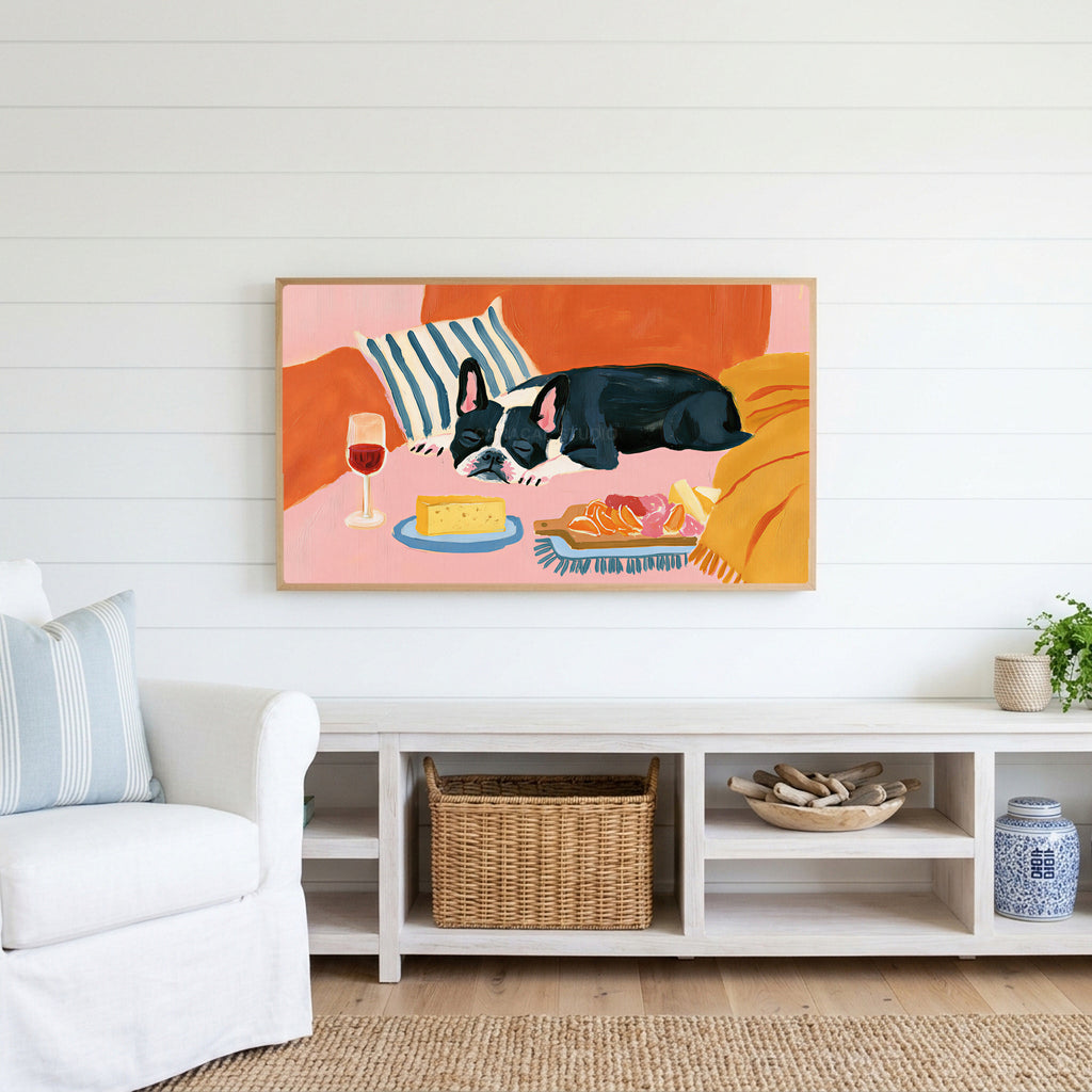 Sleeping French bulldog Frame TV art above a white console with a rattan basket in a coastal living room