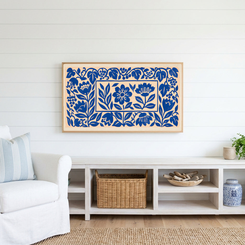 Blue paper cut flowers Frame TV art above a white console with a rattan basket in a coastal living room