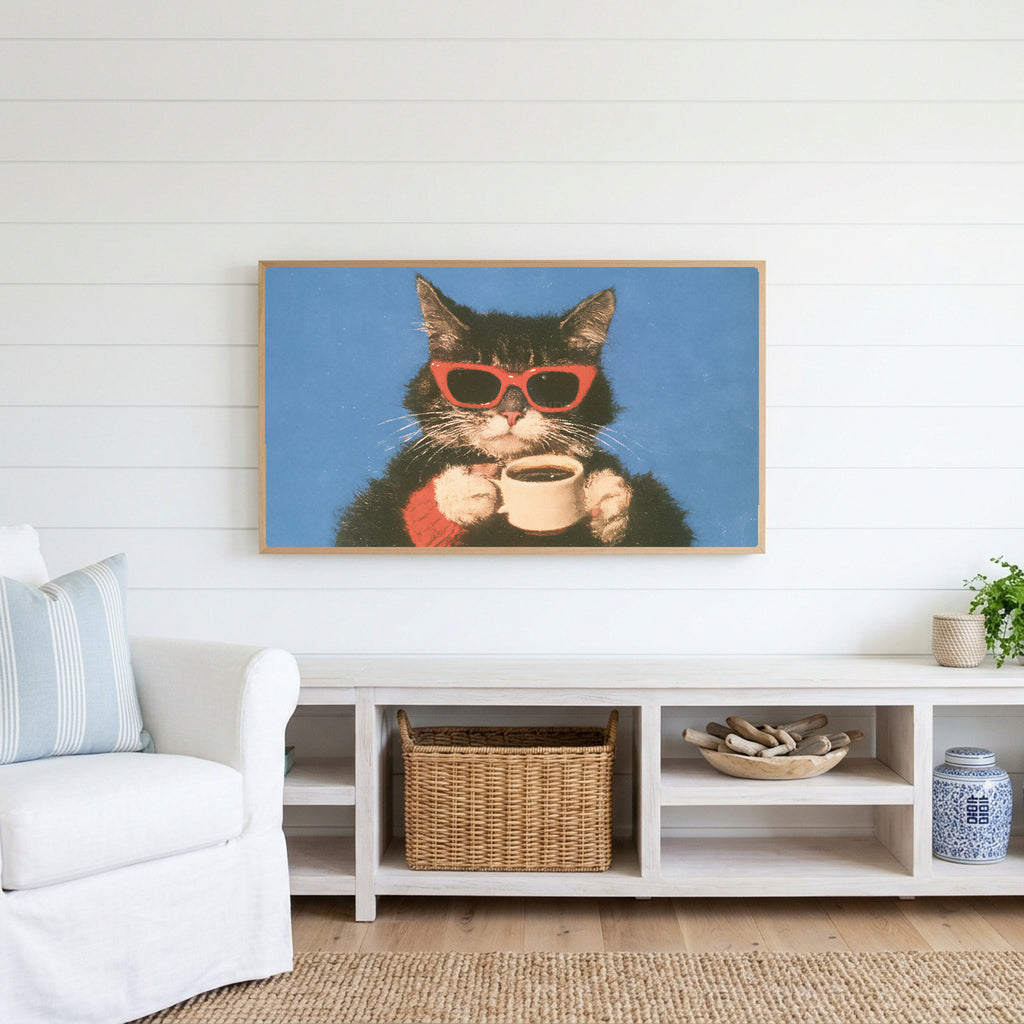 Coffee cat in sunglasses Frame TV art above a white console with a rattan basket in a coastal living room