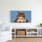 Coffee cat in sunglasses Frame TV art above a white console with a rattan basket in a coastal living room