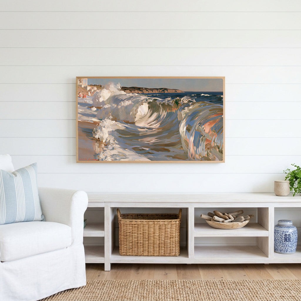 Crashing ocean waves Frame TV art above a white console with a rattan basket in a coastal living room
