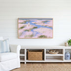 Pastel wetland walker Frame TV art above a white console with a rattan basket in a coastal living room