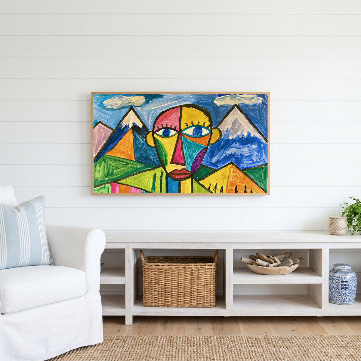 Color block face Frame TV art above a white console with a rattan basket in a coastal living room