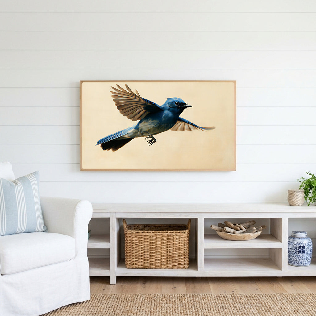 Blue flycatcher Frame TV art above a white console with a rattan basket in a coastal living room