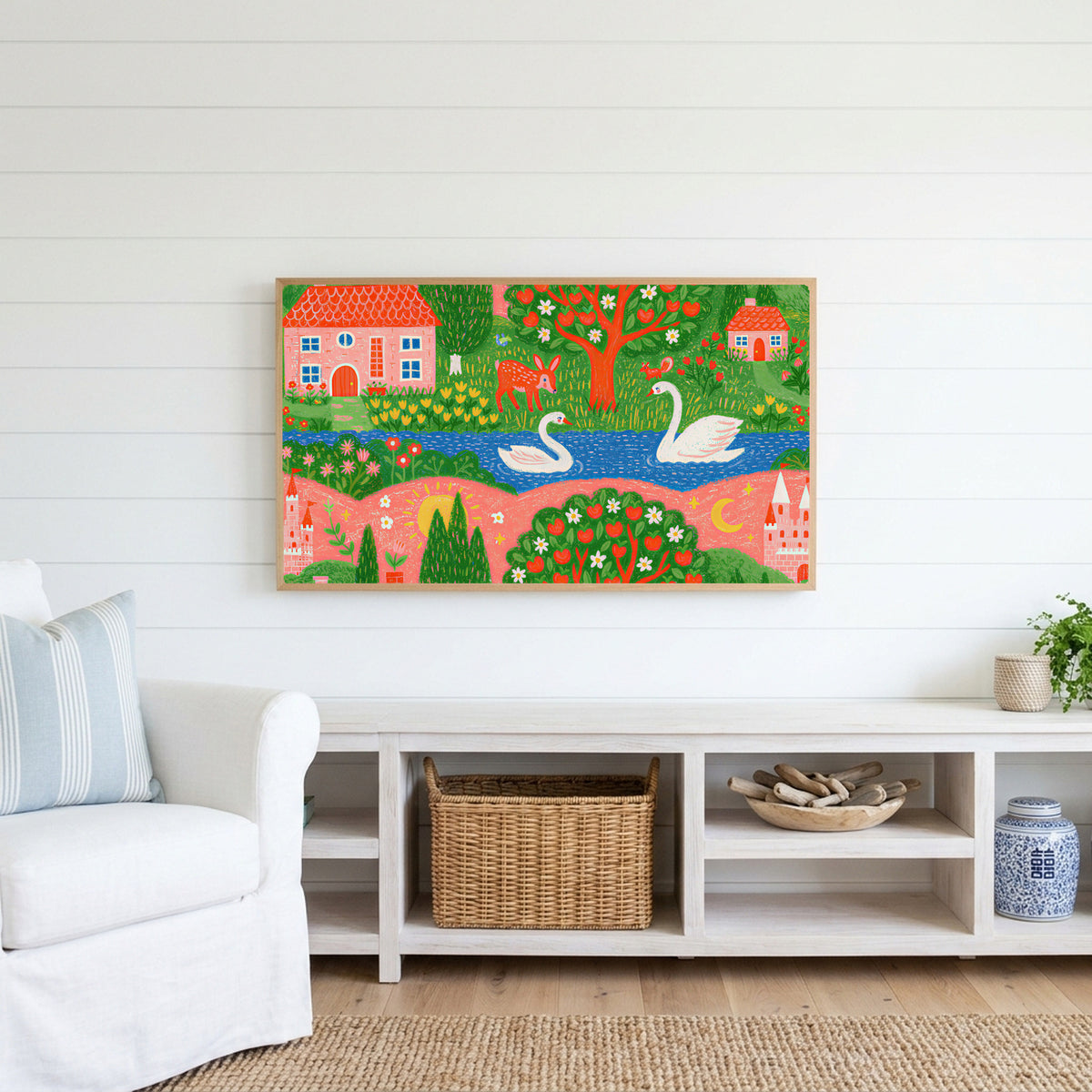 Storybook village with swans Frame TV art above a white console with a rattan basket in a coastal living room