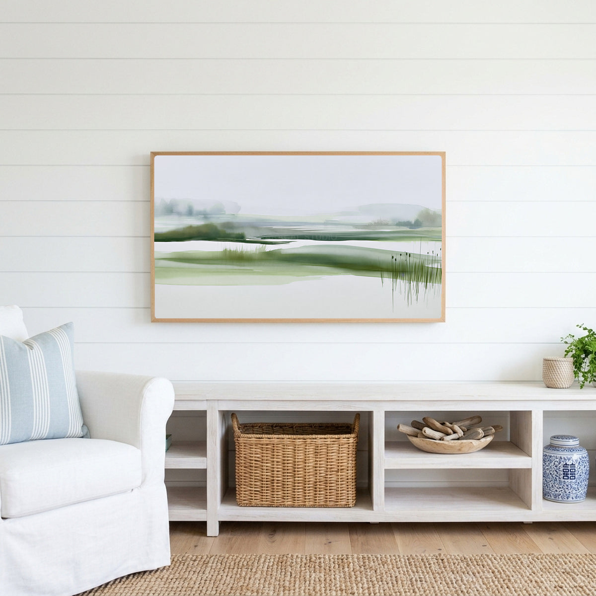 Misty wetland Frame TV art above a white console with a rattan basket in a coastal living room