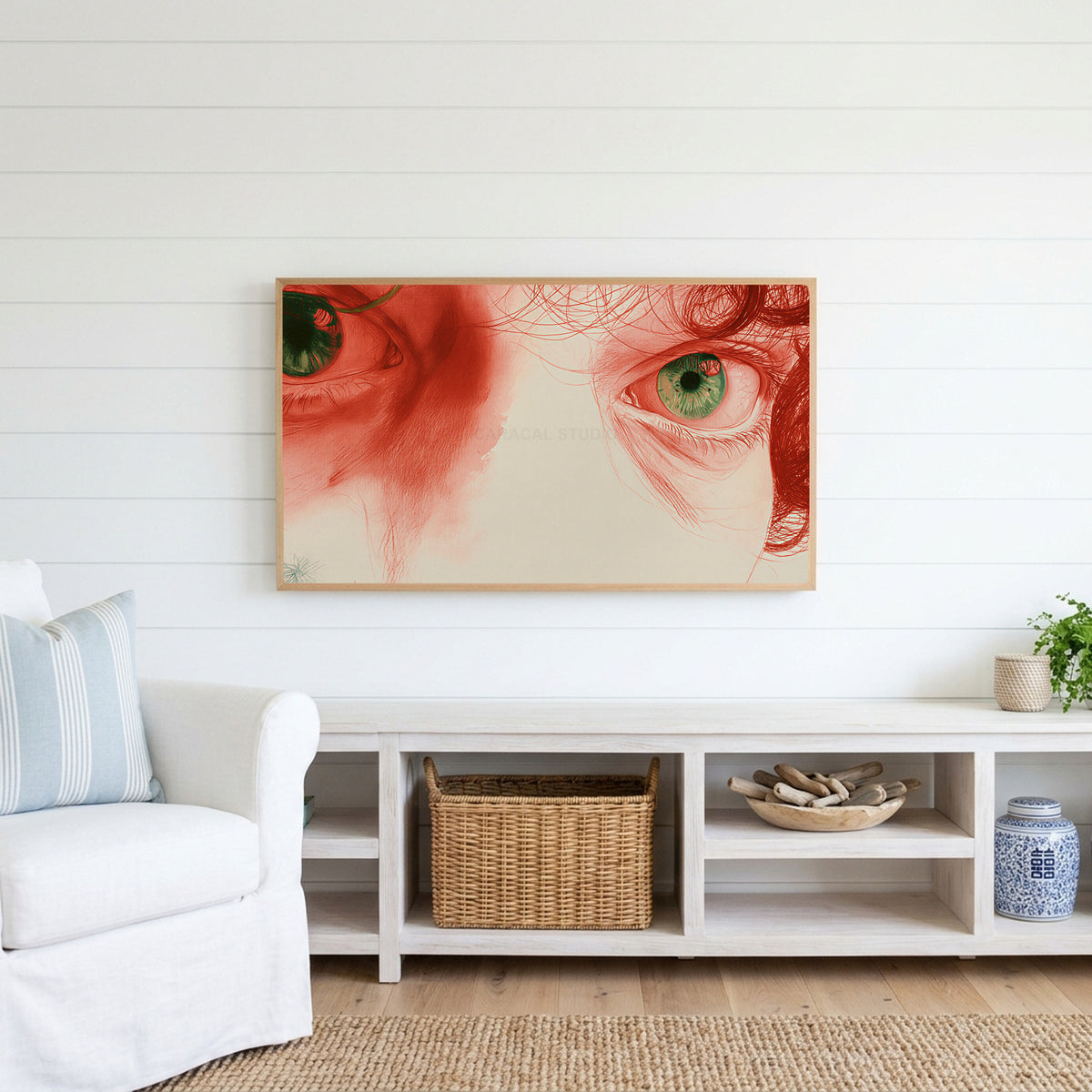 Red pencil eyes Frame TV art above a white console with a rattan basket in a coastal living room