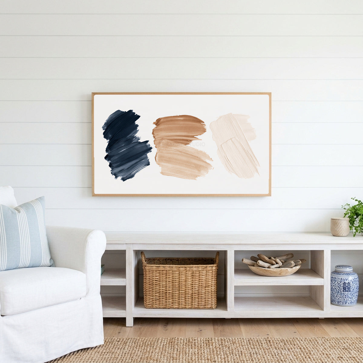 Paint stroke Frame TV art above a white console with a rattan basket in a coastal living room