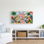 Mediterranean summer dance Frame TV art above a white console with a rattan basket in a coastal living room
