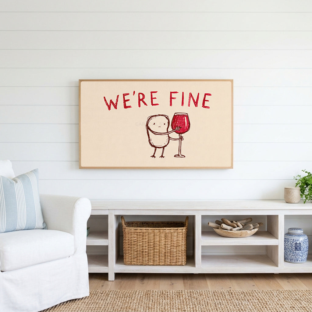 We're Fine wine doodle Frame TV art above a white console with a rattan basket in a coastal living room