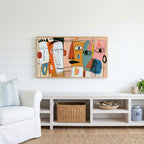 Colorful abstract faces Frame TV art above a white console with a rattan basket in a coastal living room