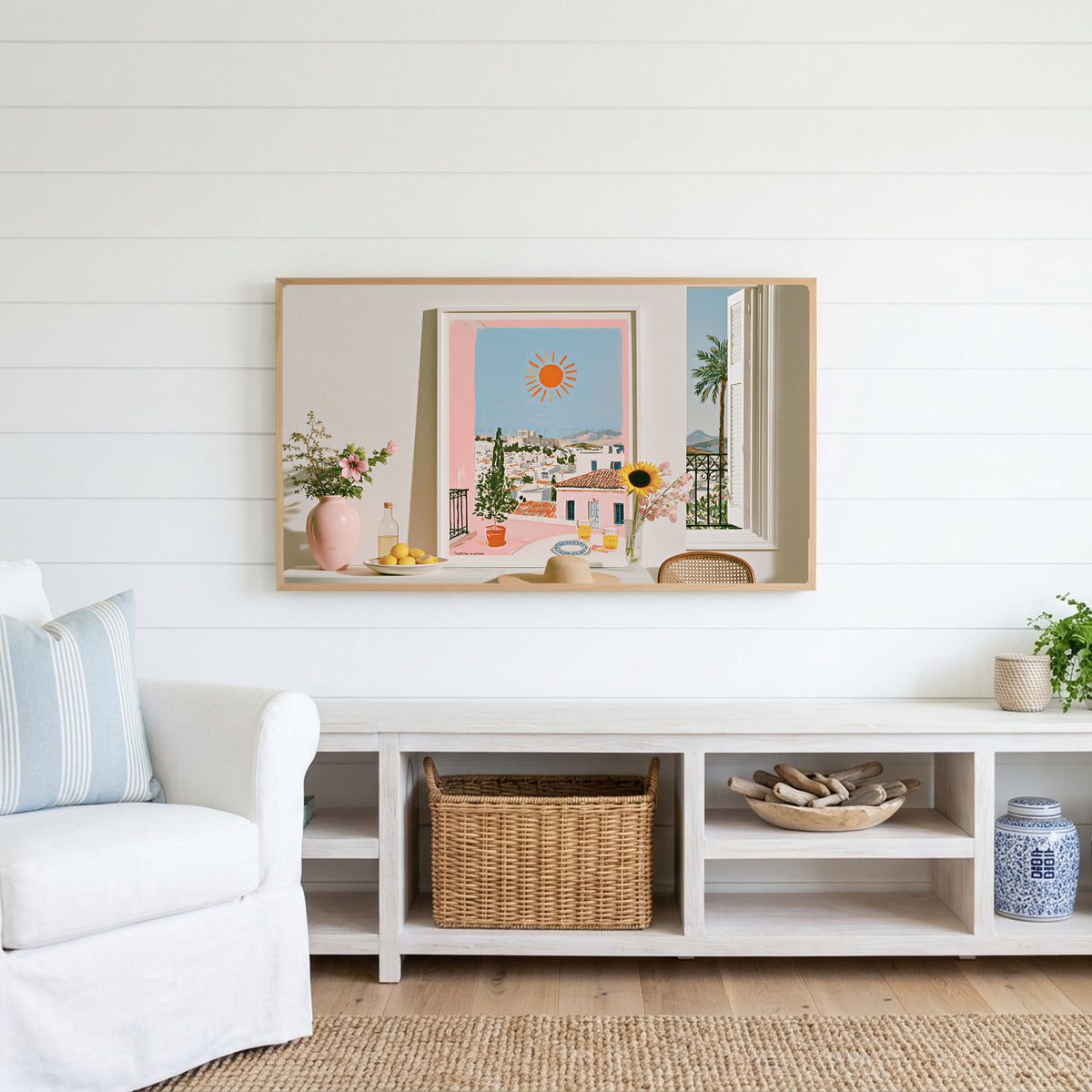 Athens summer still life Frame TV art above a white console with a rattan basket in a coastal living room