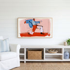 Dancing man line Frame TV art above a white console with a rattan basket in a coastal living room