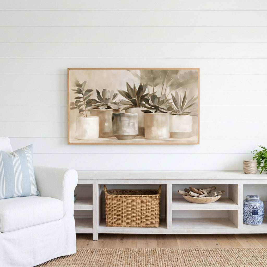 Neutral succulent pots Frame TV art above a white console with a rattan basket in a coastal living room