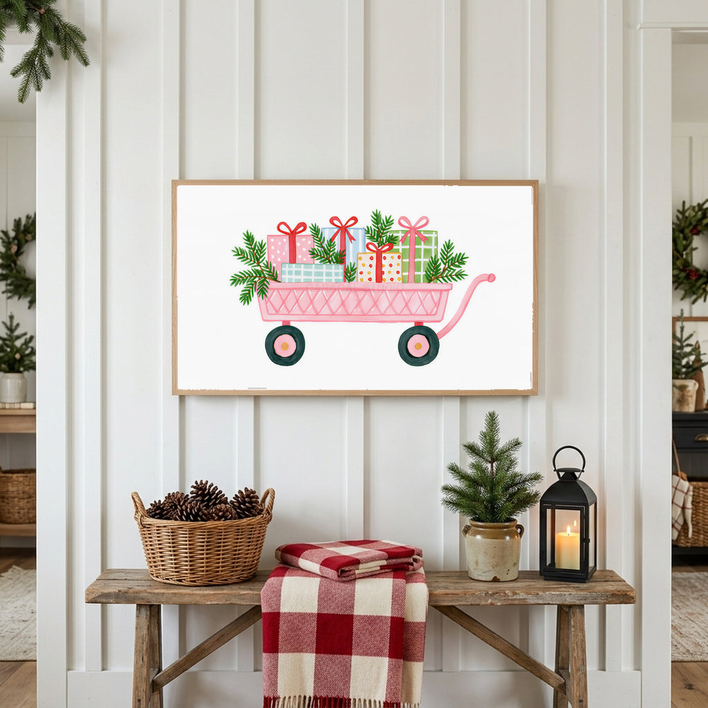 Pink wagon with gifts Frame TV art above a rustic bench with pine cones and a red check blanket on a white plank wall