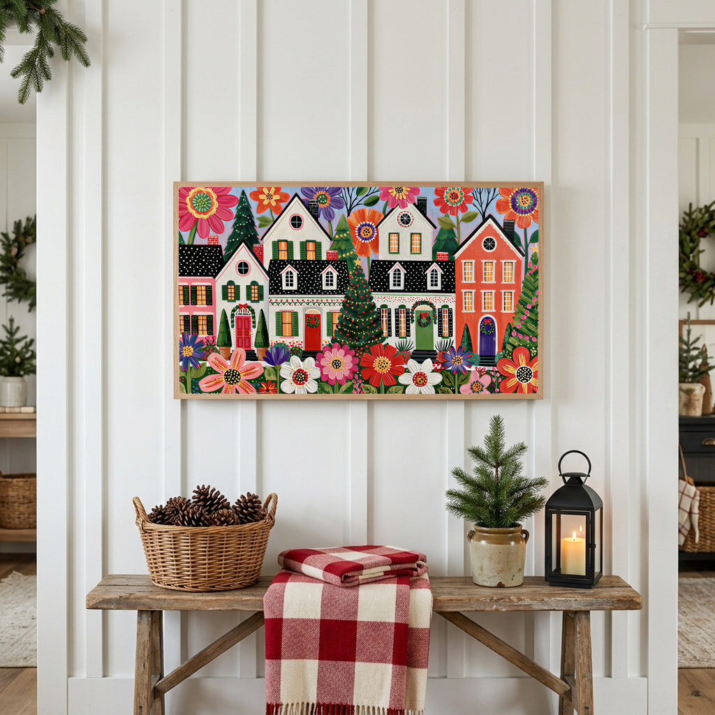 Folk art Christmas village Frame TV art above a rustic bench with pine cones and a red check blanket on a white plank wall