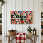 Folk art Christmas village Frame TV art above a rustic bench with pine cones and a red check blanket on a white plank wall