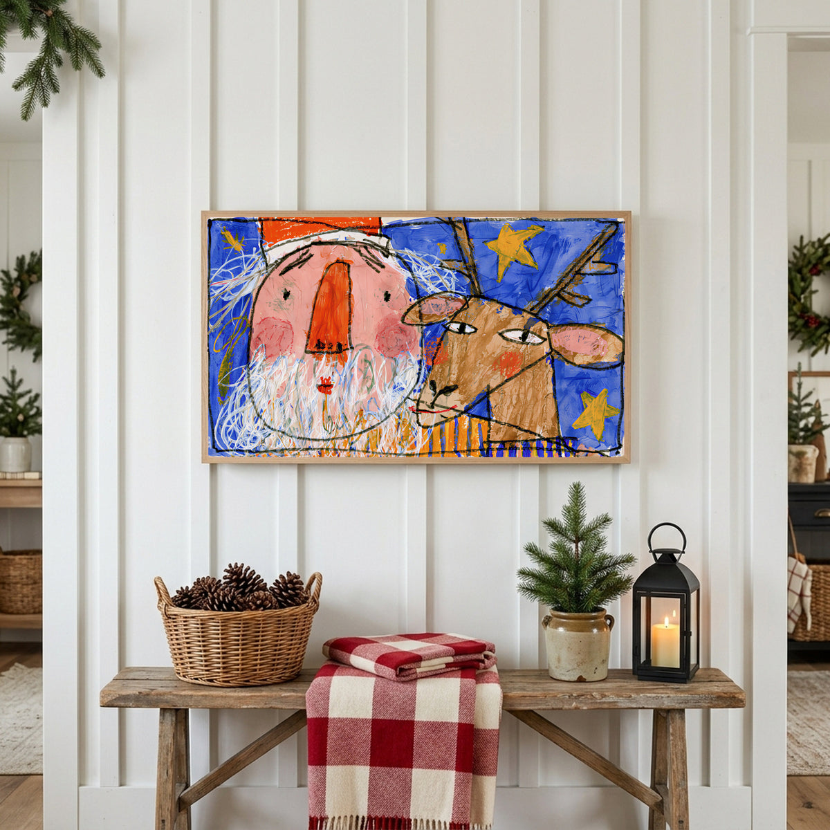 Christmas Frame TV art above a rustic bench with pine cones and a red check blanket on a white plank wall