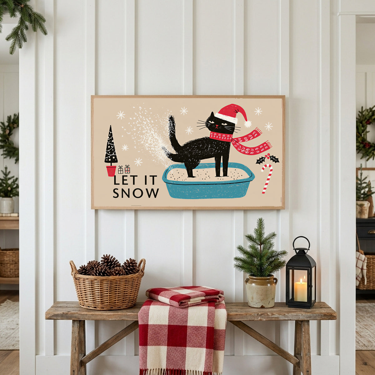 Let It Snow cat Frame TV art above a rustic bench with pine cones and a red check blanket on a white plank wall