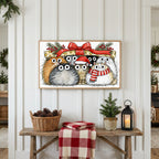Cats under a gift box Frame TV art above a rustic bench with pine cones and a red check blanket on a white plank wall