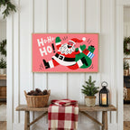 Jumping Santa Frame TV art above a rustic bench with pine cones and a red check blanket on a white plank wall