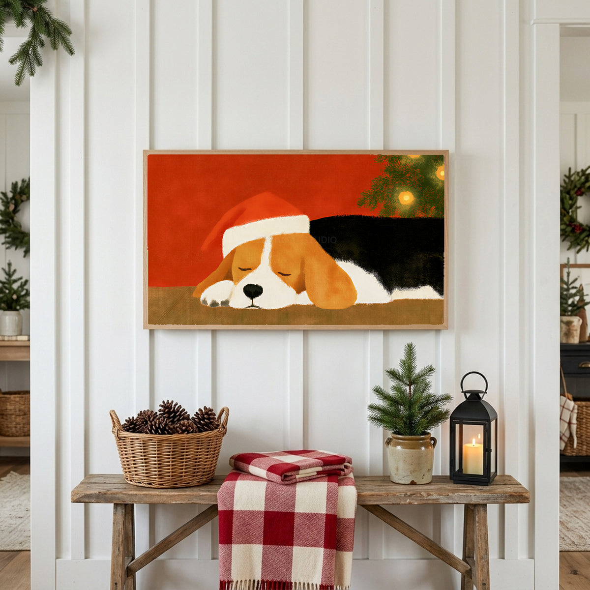 Sleeping beagle Frame TV art above a rustic bench with pine cones and a red check blanket on a white plank wall