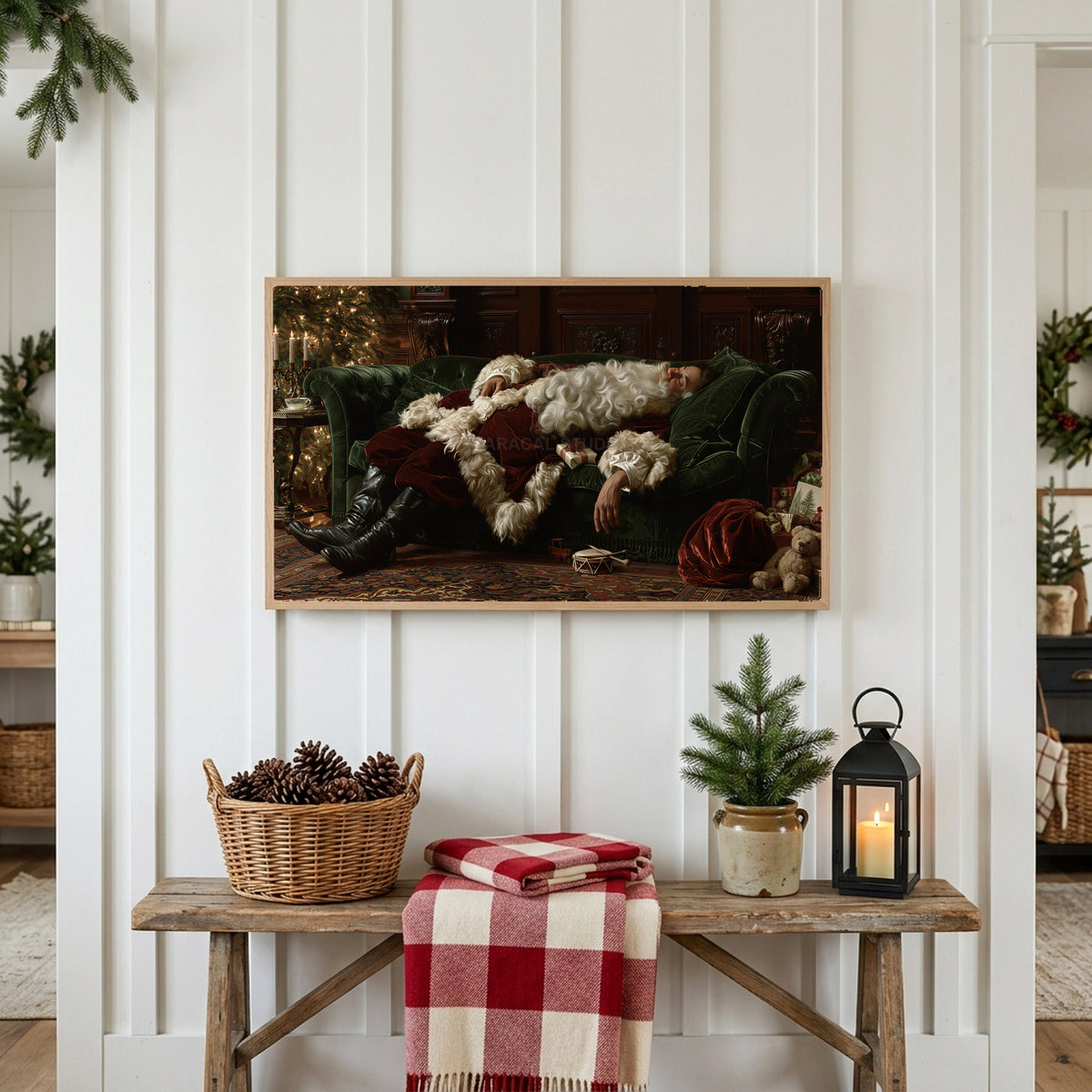 Sleeping Santa Frame TV art above a rustic bench with pine cones and a red check blanket on a white plank wall